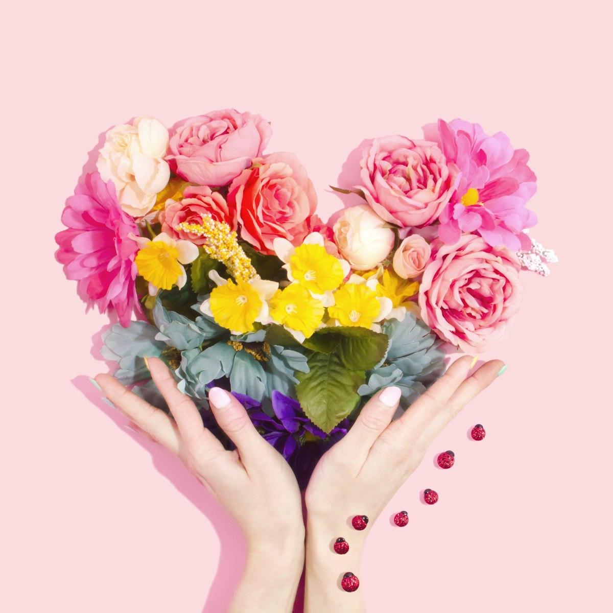 A stunning arrangement of all-time beloved flower varieties including roses peonies and sunflowers